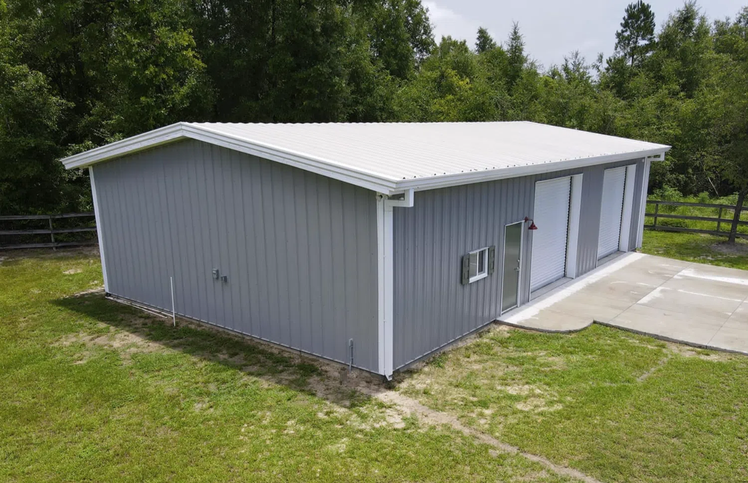 A gray building with white corners, roof, and doors, highlighting trim and flashing options.